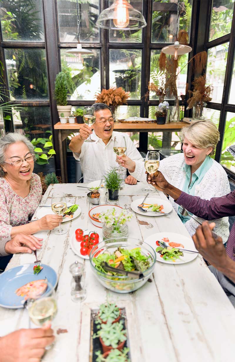 group of senior friends out for dinner keys to a successful retirement