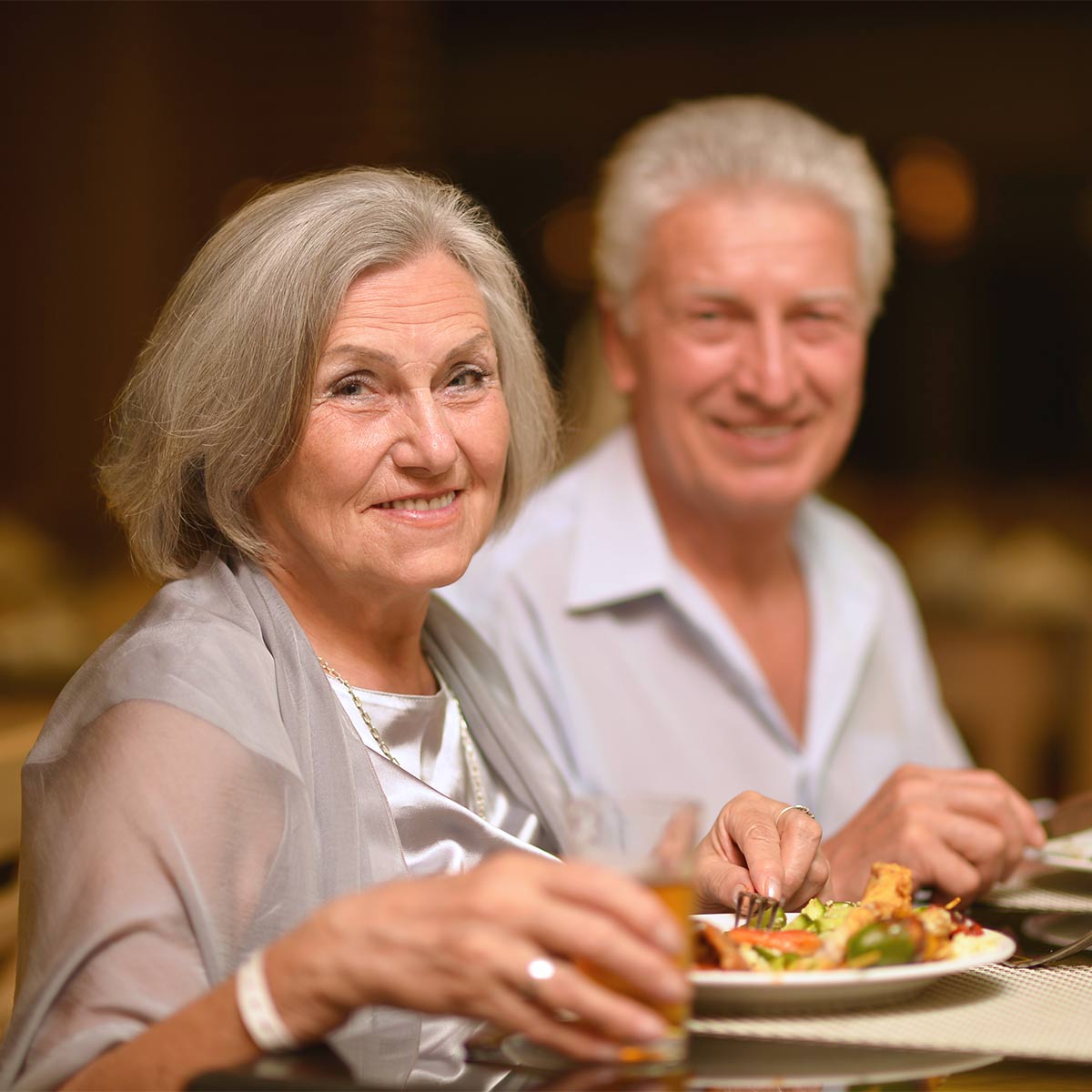 senior couple enjoying a complimentary gourmet meal at a seminar about how to plan for retirement