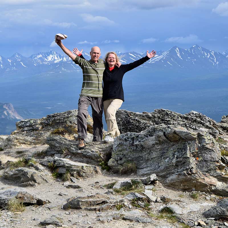 seniors posing at the top of hiking destination retirement made simple