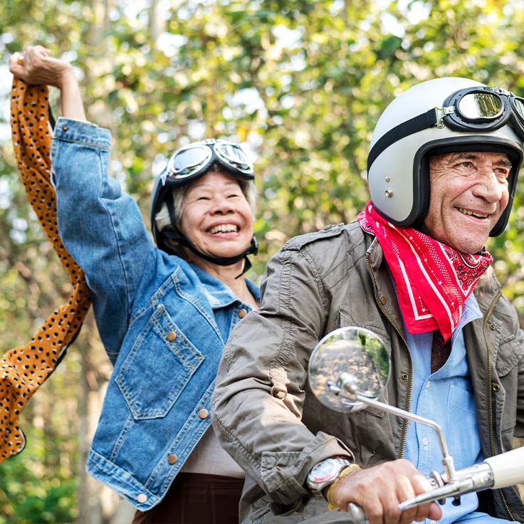 smiling senior couple riding motorcycle safe retirement income strategies