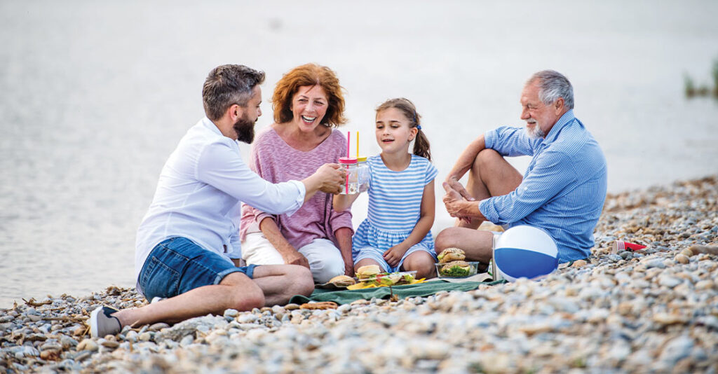 grandparents on the beach with their son and granddaughter fixed index annuity rates